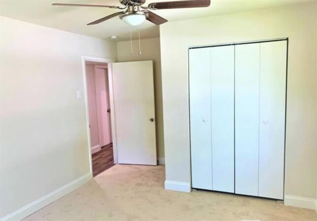 2536 Rutherford Street Irving, TX 75062 - Photo 13 of 19 Room featuring neutral carpet flooring, a ceiling fan with light fixture, and white bi-fold closet doors