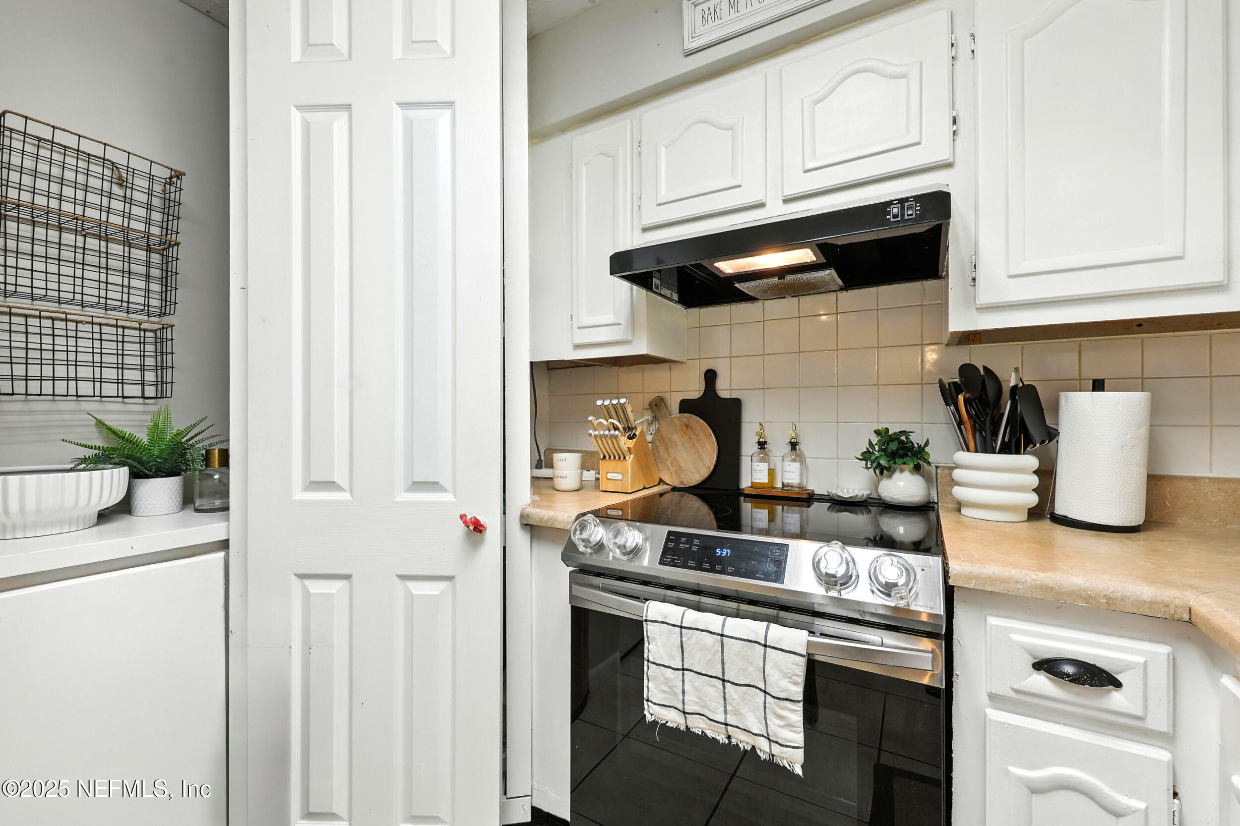 11599 Lake Ride Drive Jacksonville, FL 32223 - Photo 12 of 38 a kitchen with stainless steel appliances granite countertop white cabinets and a stove