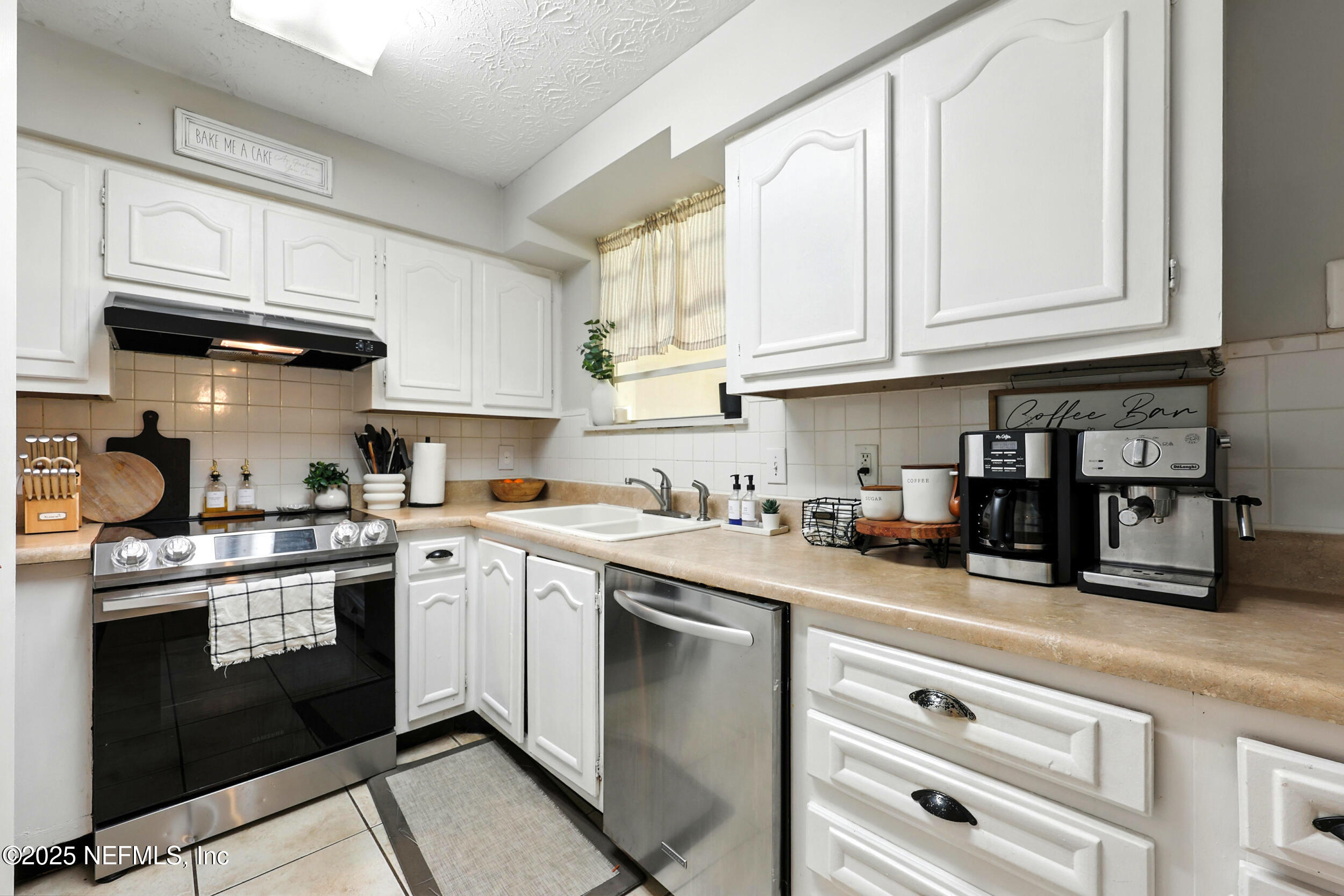 11599 Lake Ride Drive Jacksonville, FL 32223 - Photo 14 of 38 a kitchen with stainless steel appliances granite countertop a sink a stove and cabinets