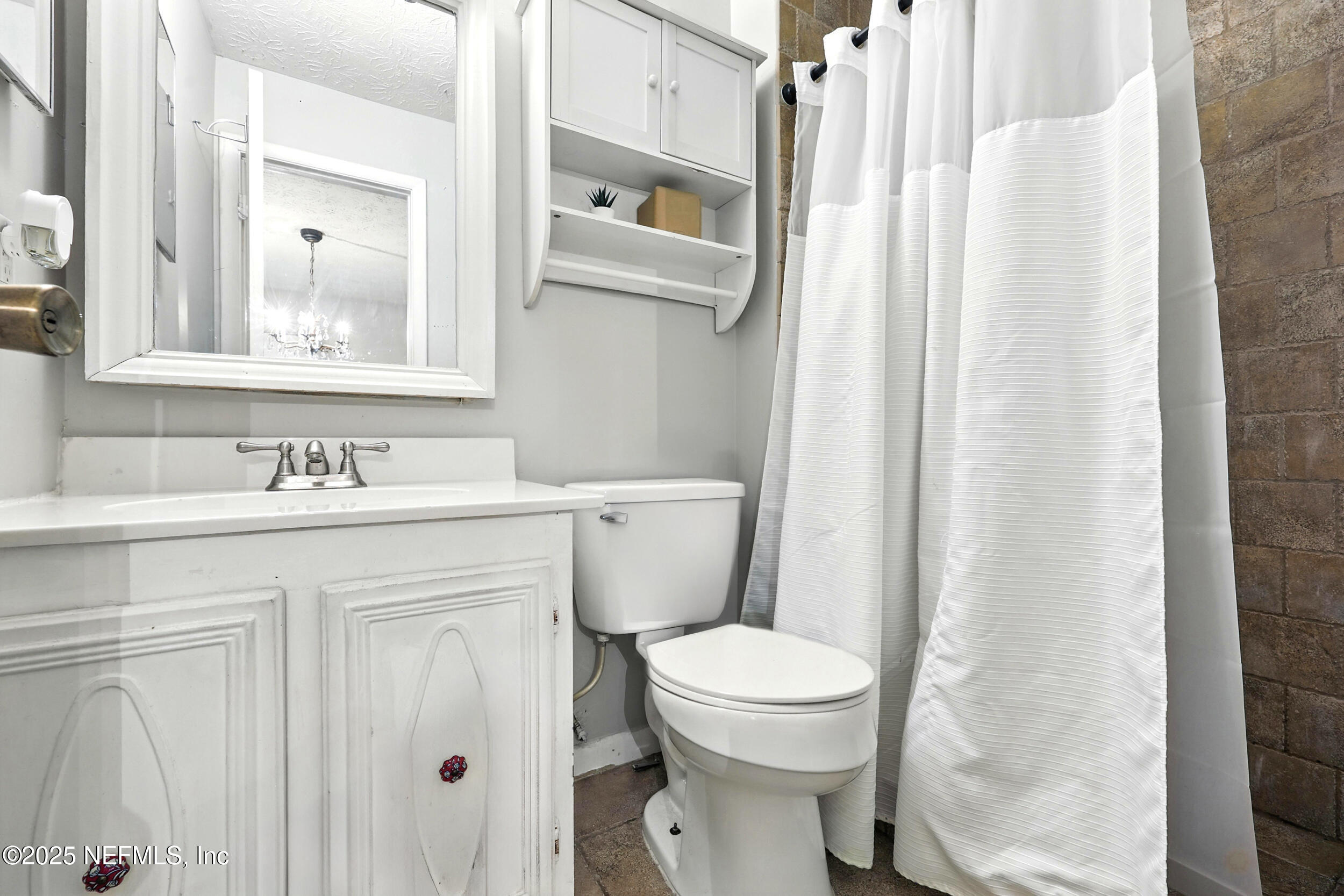 11599 Lake Ride Drive Jacksonville, FL 32223 - Photo 21 of 38 a bathroom with a sink a toilet and shower curtain