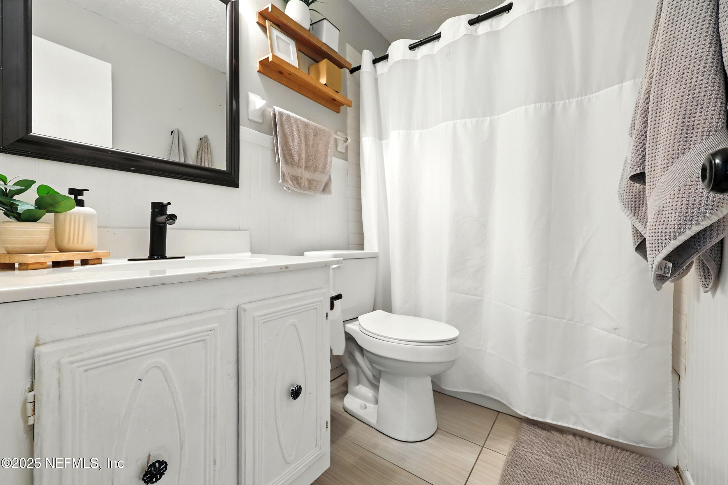 11599 Lake Ride Drive Jacksonville, FL 32223 - Photo 23 of 38 a bathroom with a sink toilet and shower