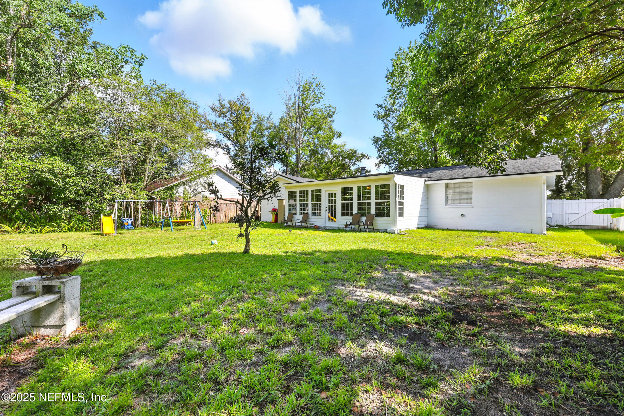 11599 Lake Ride Drive Jacksonville, FL 32223 - Photo 32 of 38 a view of a house with a backyard