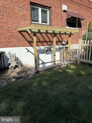 a view of a backyard with plants and patio
