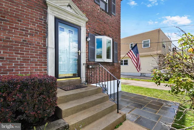 a view of a house with a small yard and a fountain