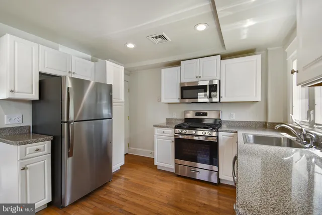 a kitchen with a refrigerator stove and microwave
