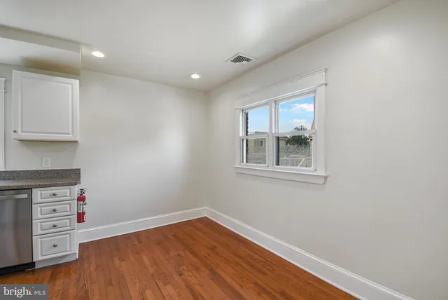 a view of workspace with wooden floor and window