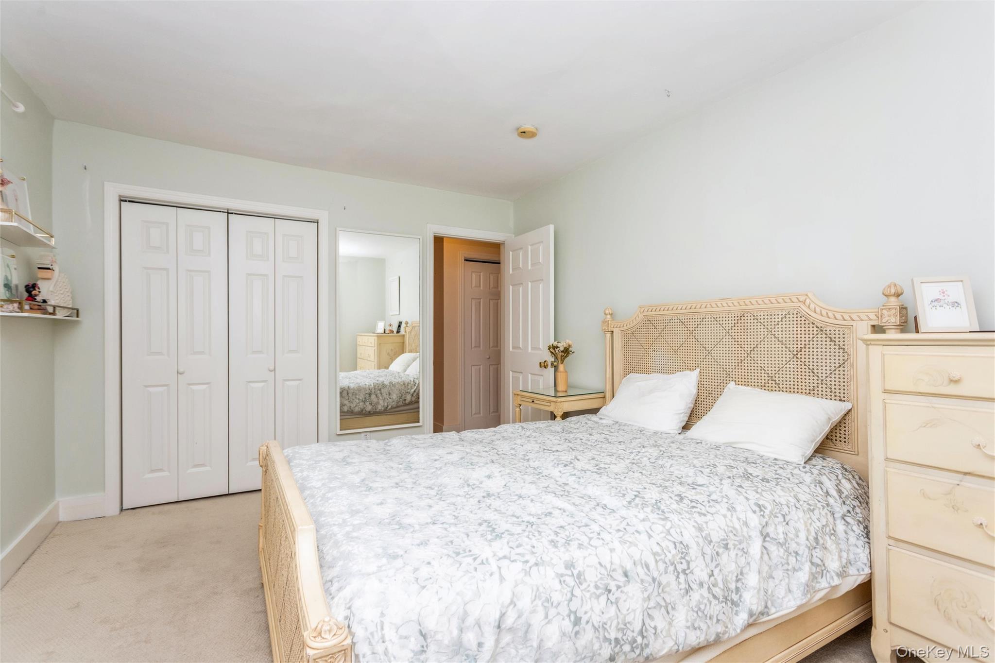 61 Manchester Road, Unit A21 Eastchester, NY 10709 - Photo 16 of 25 a bedroom with a large bed and walk in closet