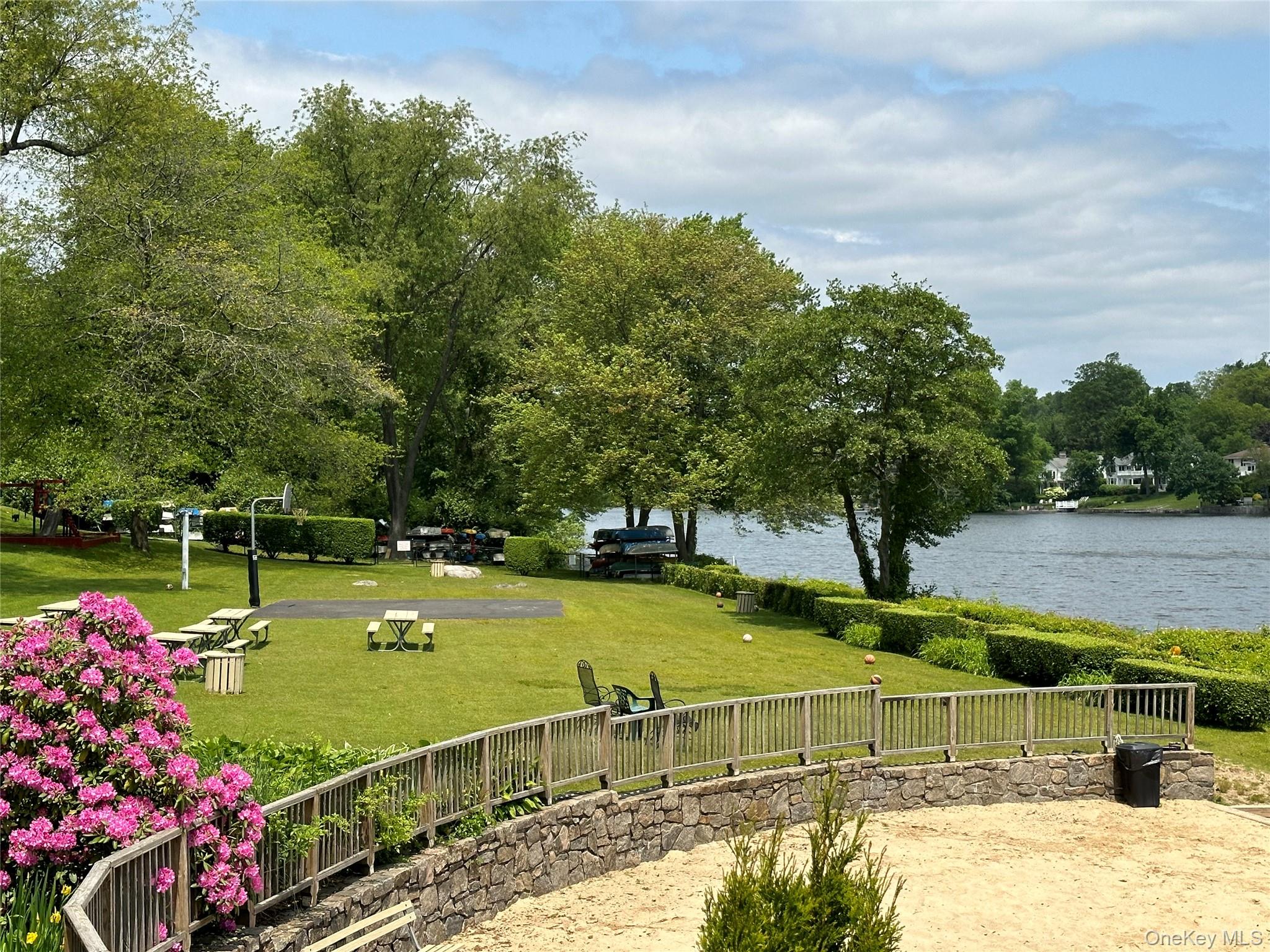 61 Manchester Road, Unit A21 Eastchester, NY 10709 - Photo 20 of 25 a view of a swimming pool with a chair and tables