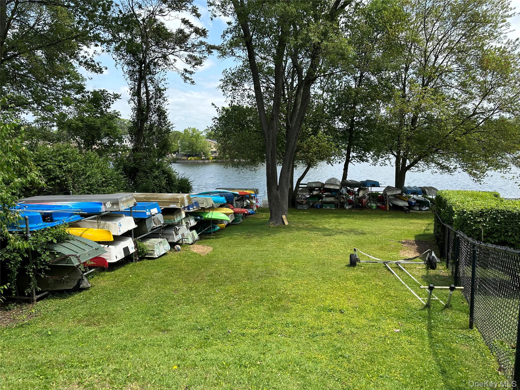61 Manchester Road, Unit A21 Eastchester, NY 10709 - Photo 21 of 25 a view of a swimming pool with lawn chairs and plants