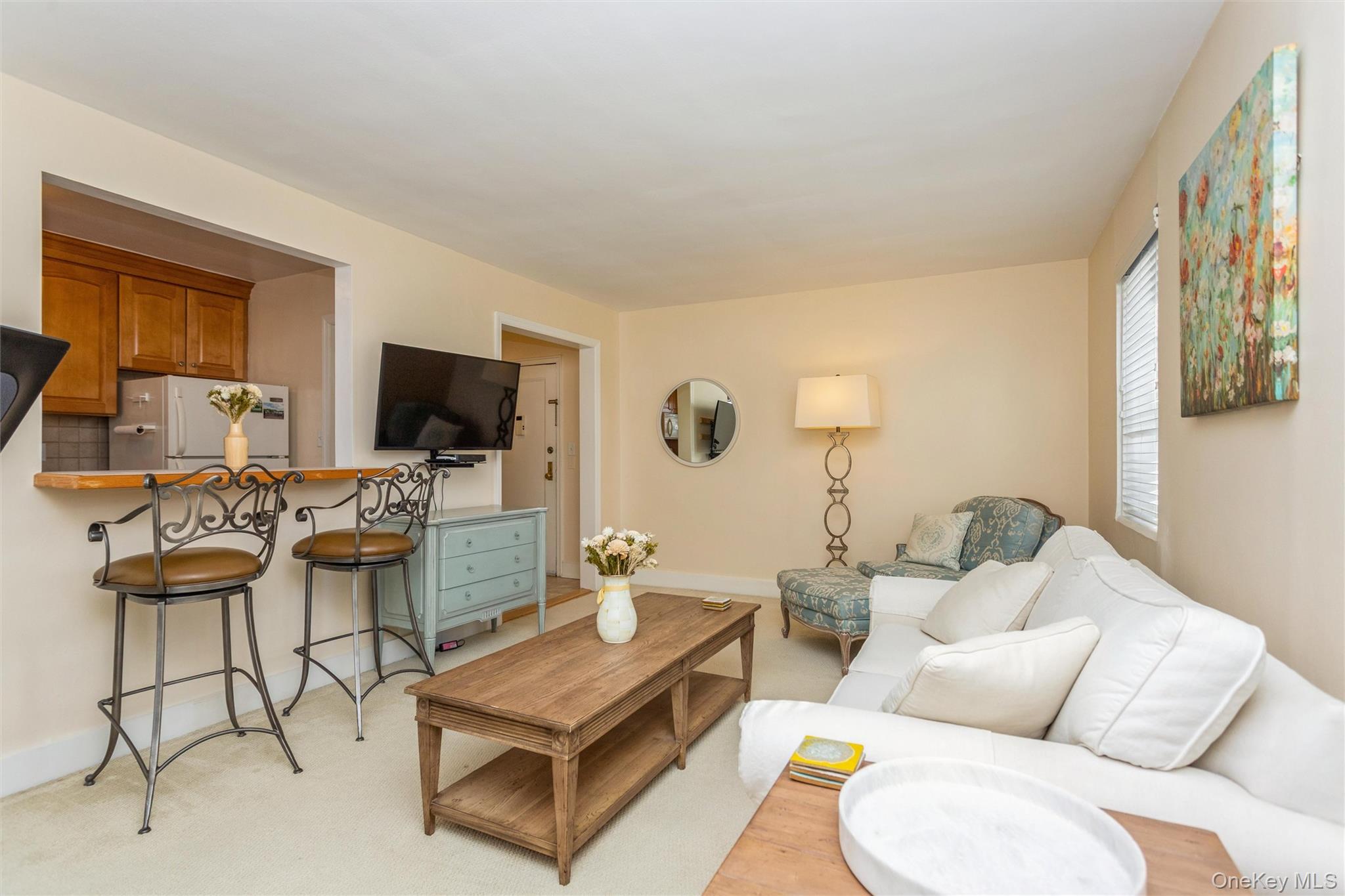 61 Manchester Road, Unit A21 Eastchester, NY 10709 - Photo 6 of 25 a living room with furniture and a flat screen tv