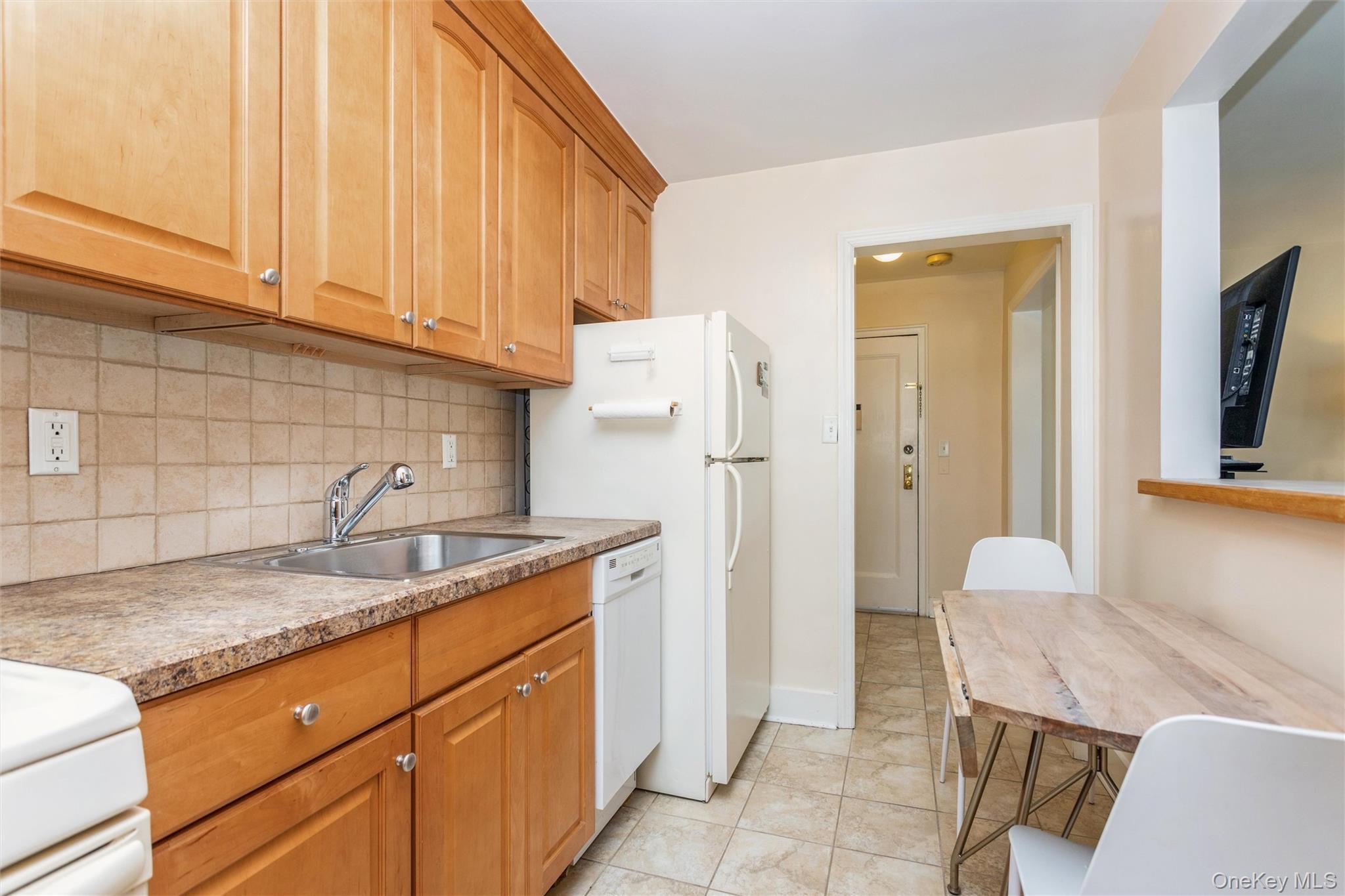 61 Manchester Road, Unit A21 Eastchester, NY 10709 - Photo 9 of 25 a kitchen with a granite countertop sink and cabinets