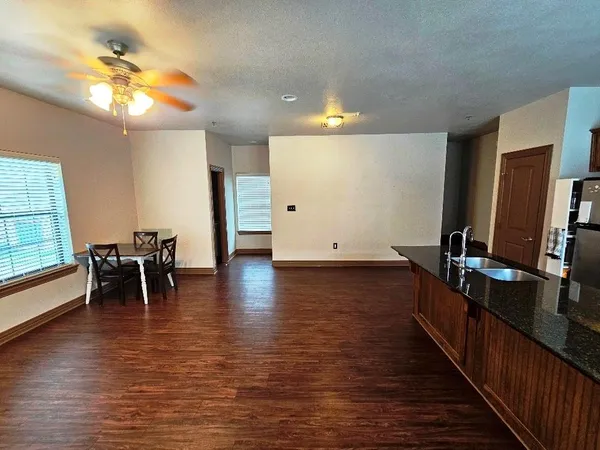 a kitchen with stainless steel appliances granite countertop a stove and a wooden floors