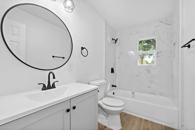 a bathroom with a sink a toilet and a mirror