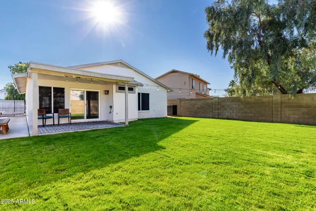 a view of a house with a yard and sitting area
