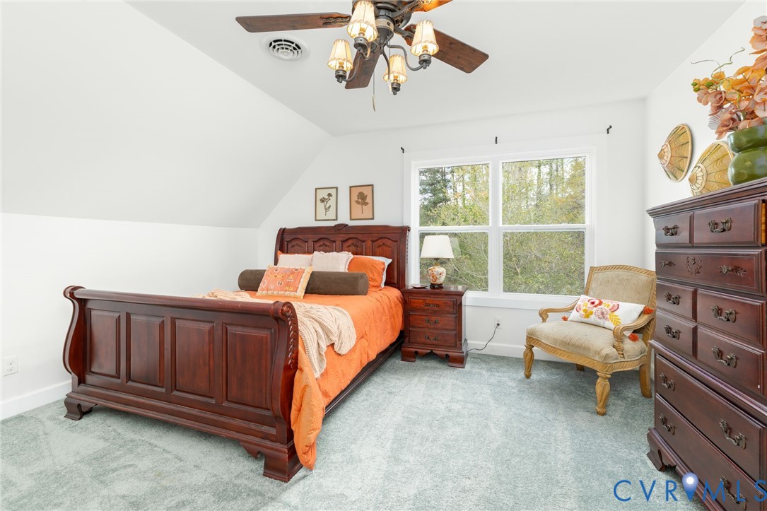 1895 Cemetery Road Chase City, VA 23924 - Photo 26 of 83 a bedroom with a bed and a chandelier