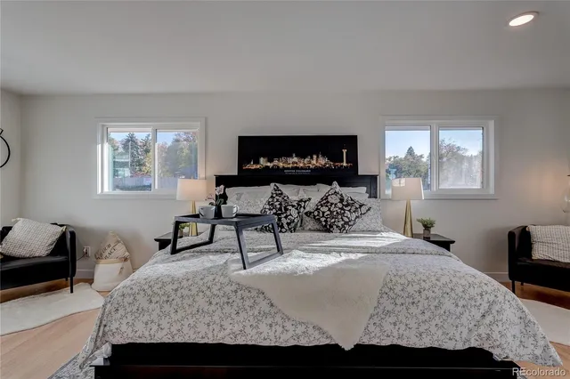 a bedroom with a bed a mirror and a window