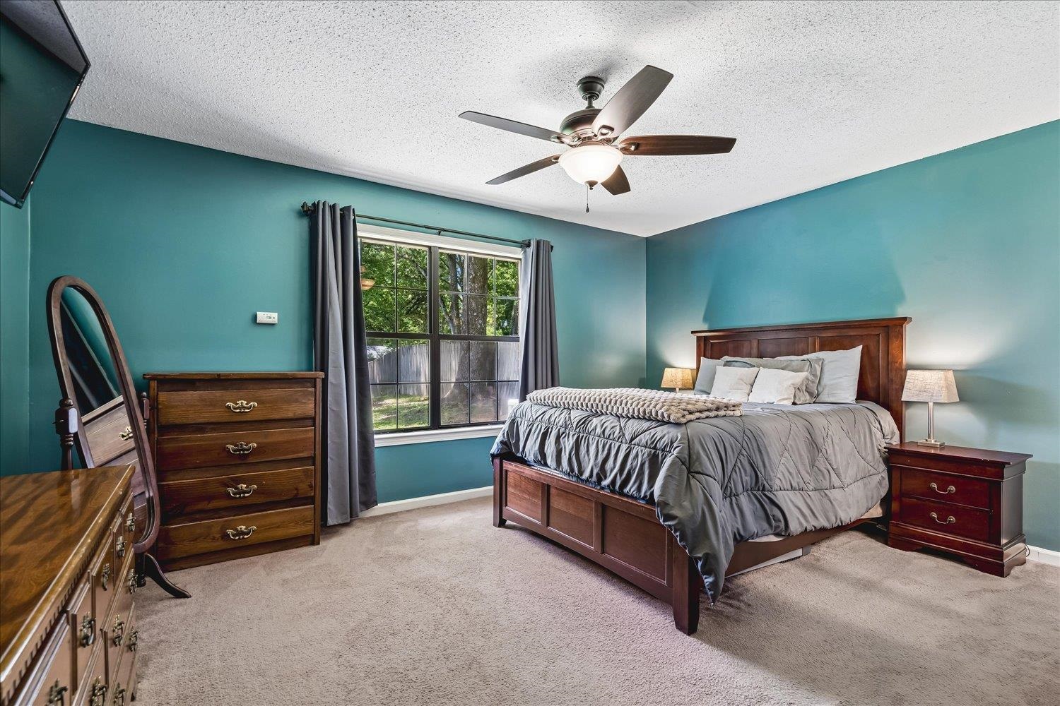 5711 Yale Road Bartlett, TN 38134 - Photo 13 of 29 Room featuring a large window, a ceiling fan with integrated lighting, and carpeted flooring
