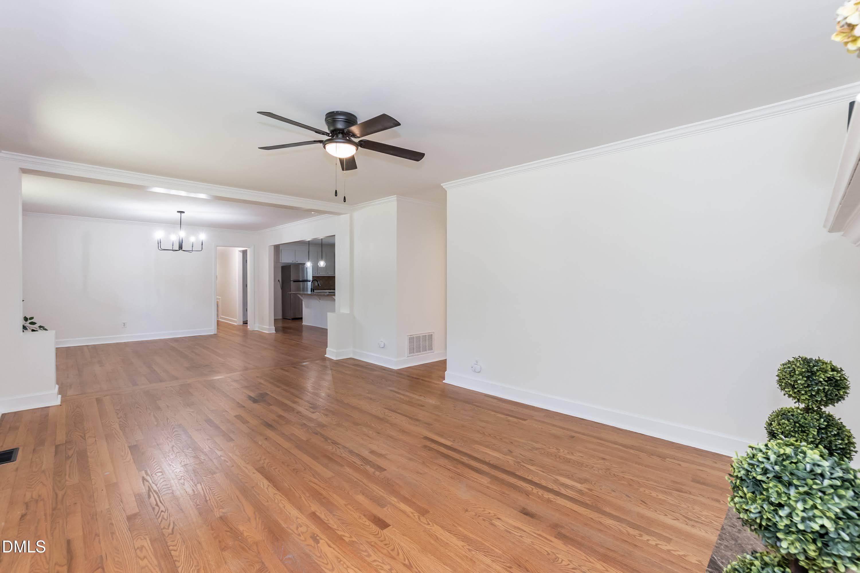 641 Rocky Ford Road Louisburg, NC 27549 - Photo 27 of 38 a view of a room with wooden floor and a ceiling fan