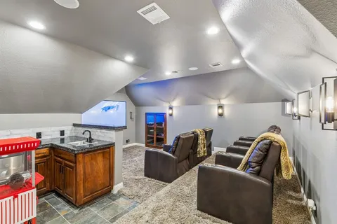 a kitchen with stainless steel appliances kitchen island granite countertop a stove a sink and a refrigerator