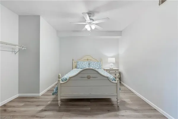 a bedroom with a bed and a ceiling fan