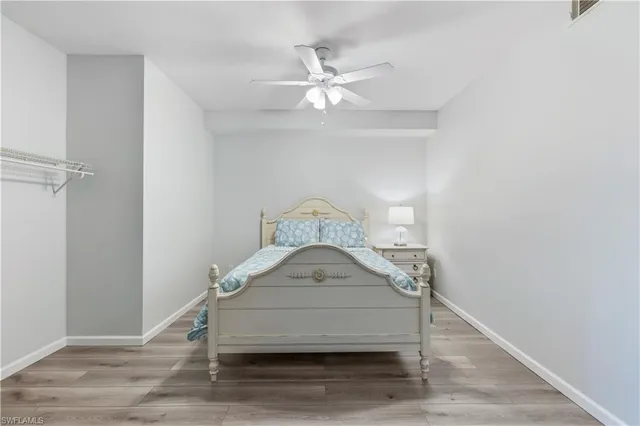 a bedroom with a bed and a ceiling fan