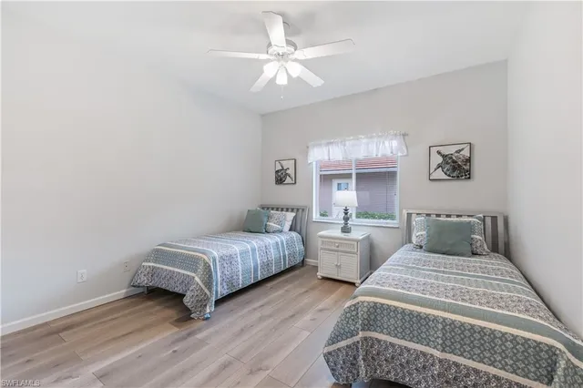a bedroom with two beds and a chandelier