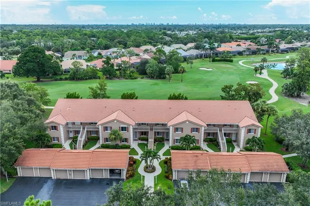 a view of a house with a garden and outdoor seating