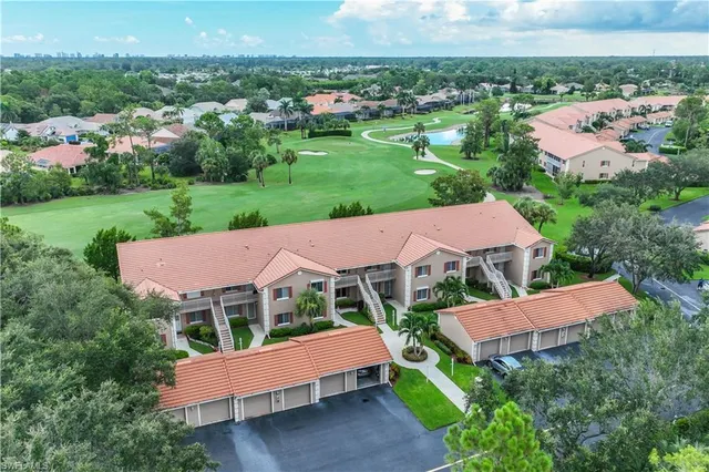 an aerial view of a house with yard and green space
