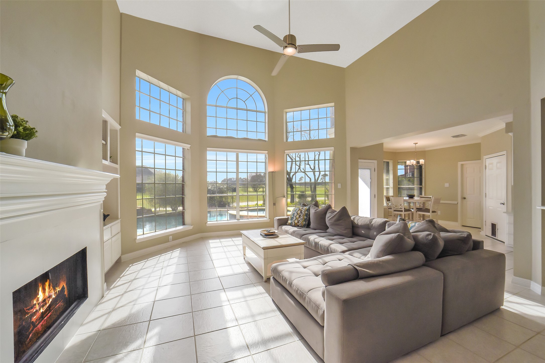 24403 Falcon Point Drive Katy, TX 77494 - Photo 5 of 32 The living area boasts a magnificent wall of windows with views of the backyard, in addition to the high ceilings and fireplace the open layout make this living room a perfect gathering spot.