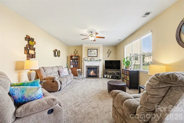 a bedroom with a bed and a ceiling fan
