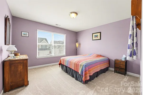 a bedroom with furniture and a window