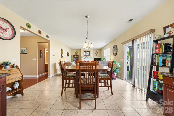a view of a dining room with furniture and chandelier