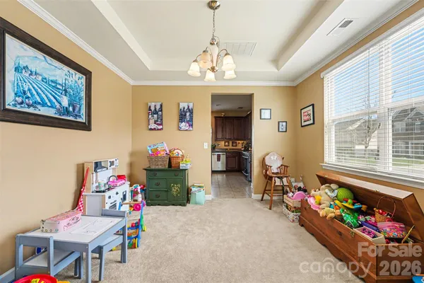 a living room with couches a dining table kitchen view and kitchen view