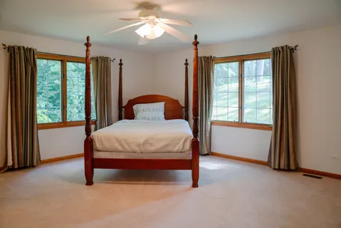 a bed sitting in a room next to a window