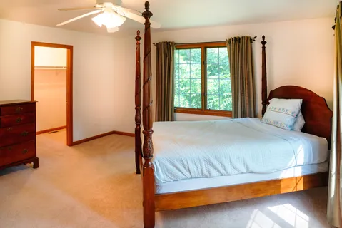 a bedroom with a bed and window