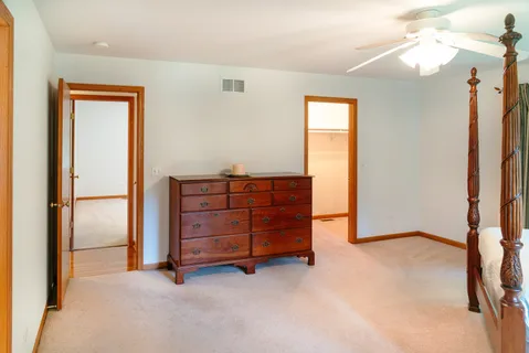 a view of an empty room with cabinet mirror and a window