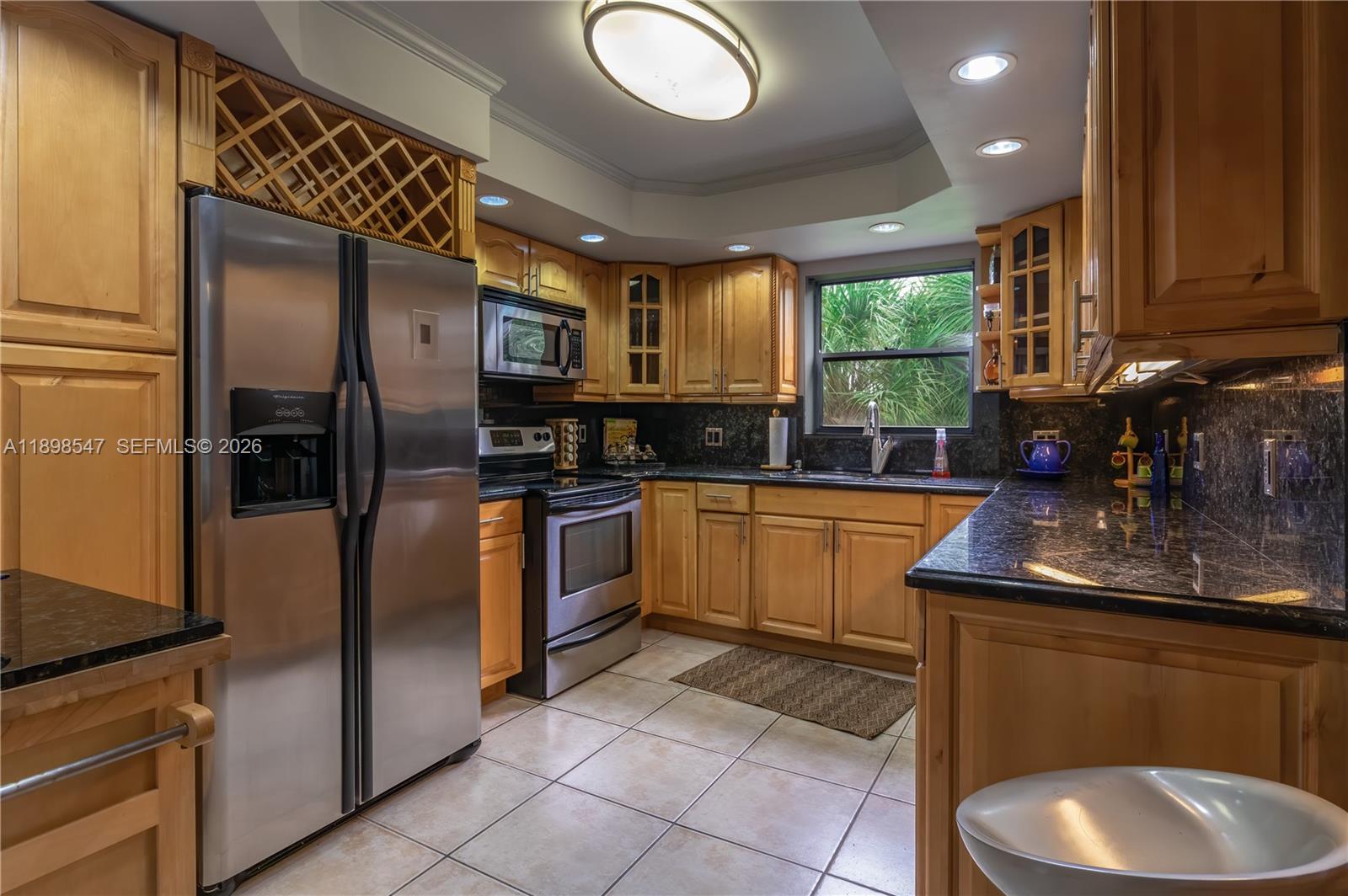16200 Golf Club Road, Unit 312 Weston, FL 33326 - Photo 6 of 31 a kitchen with stainless steel appliances granite countertop a sink a stove and a refrigerator