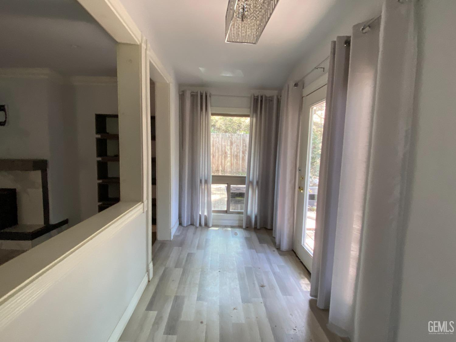 Undisclosed Address Posey, CA 93260 - Photo 14 of 21 a view of a hallway with wooden floor and a window