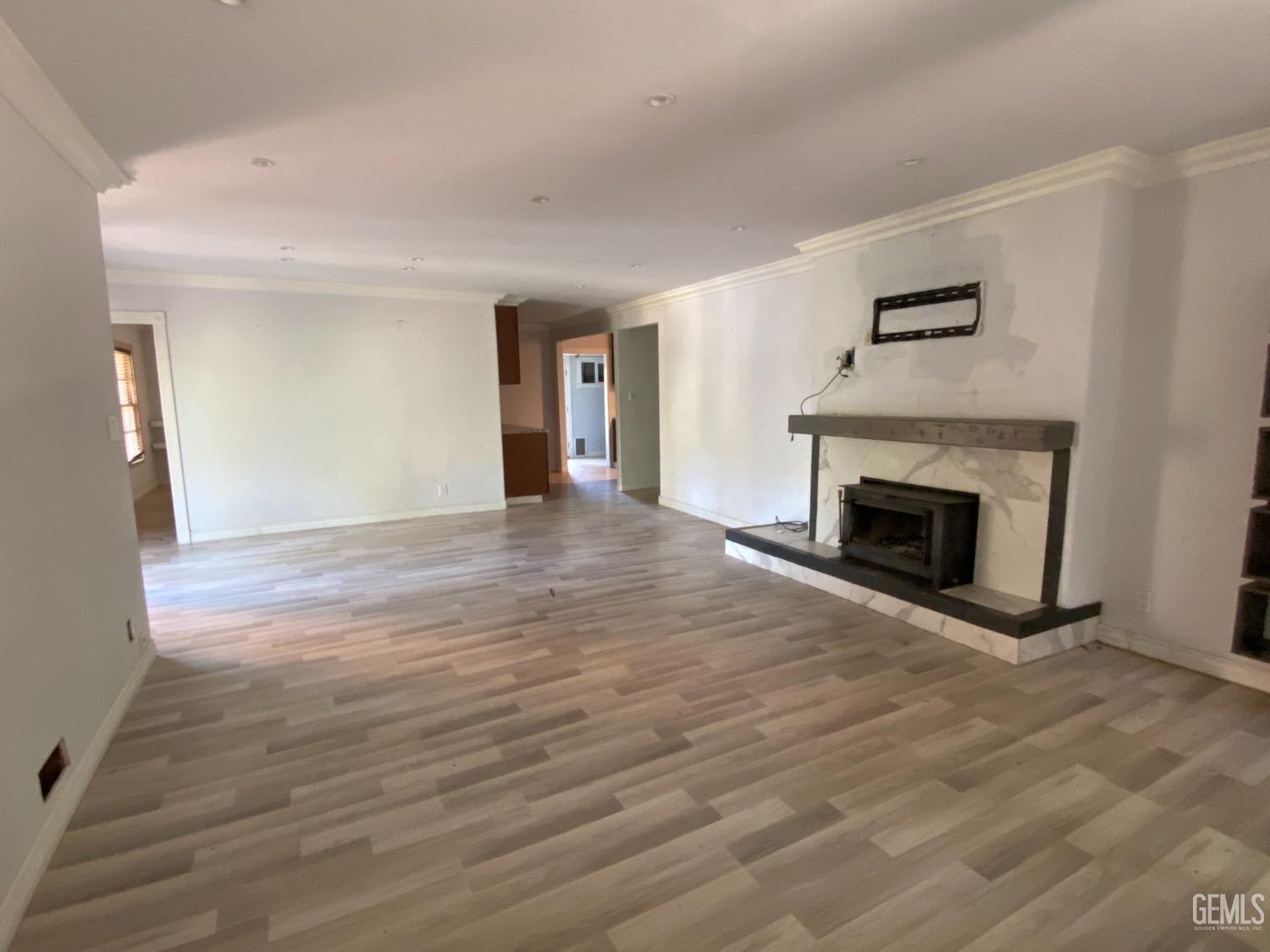 Undisclosed Address Posey, CA 93260 - Photo 15 of 21 a view of an empty room with wooden floor fireplace and a window