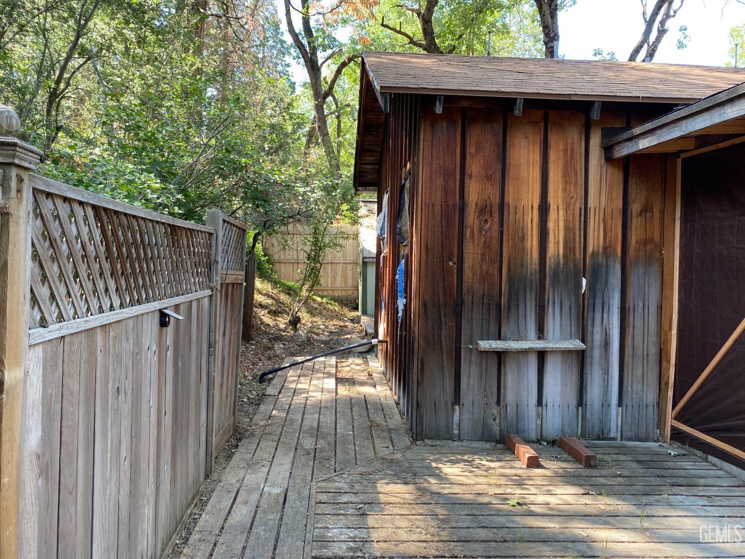 Undisclosed Address Posey, CA 93260 - Photo 19 of 21 a view of a house with a wooden fence