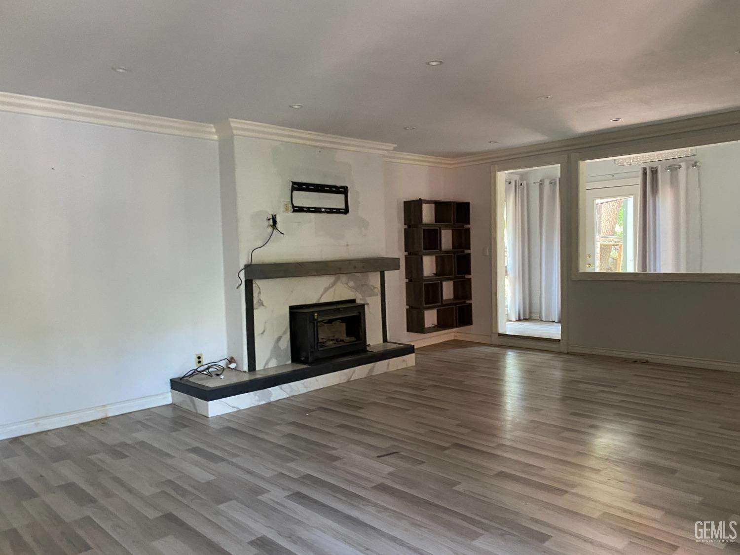 Undisclosed Address Posey, CA 93260 - Photo 7 of 21 a view of an empty room with wooden floor fireplace and a window