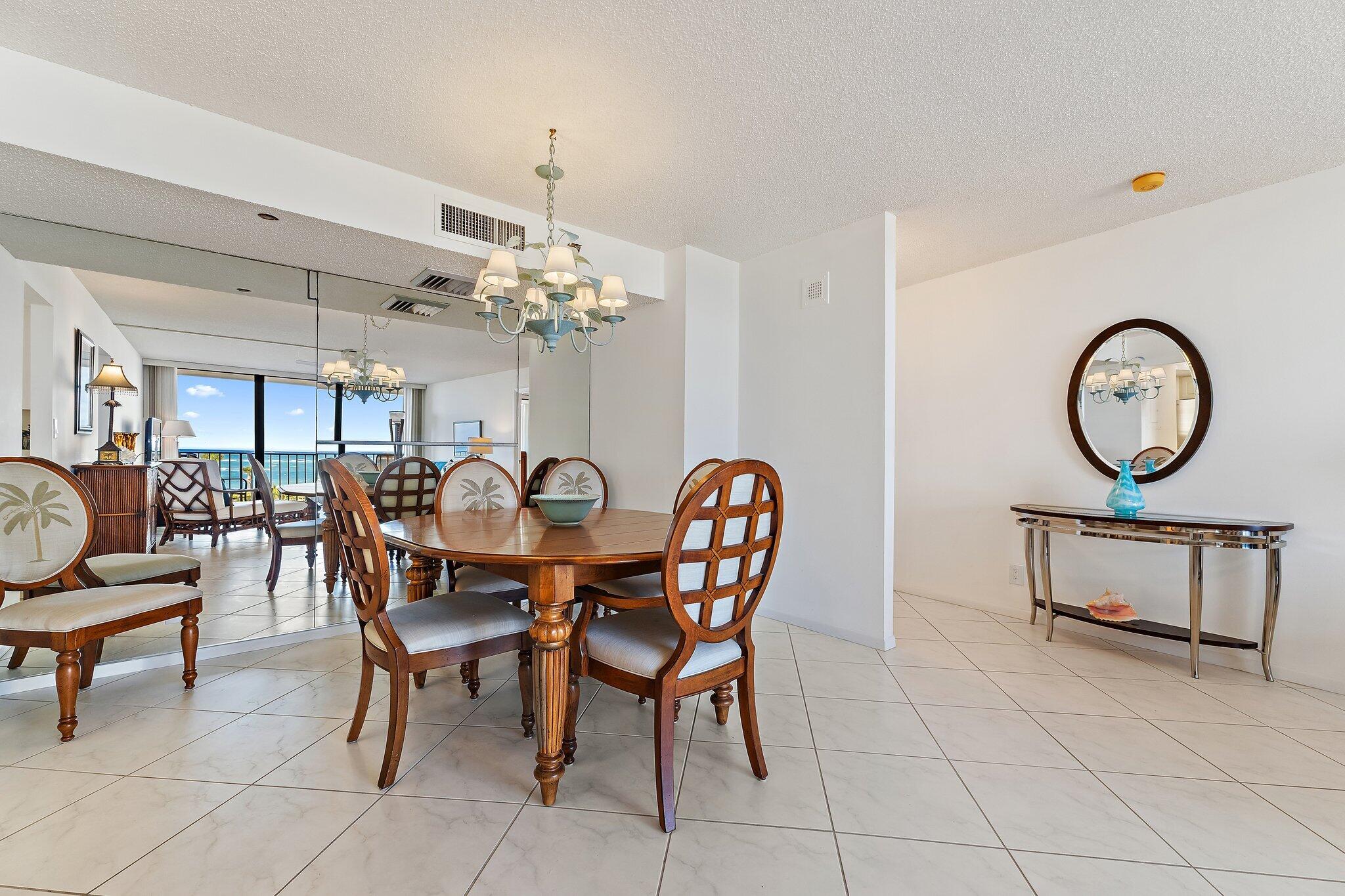 100 Ocean Trail Way, Unit 405 Jupiter, FL 33477 - Photo 12 of 38 a view of a dining room with furniture and a chandelier