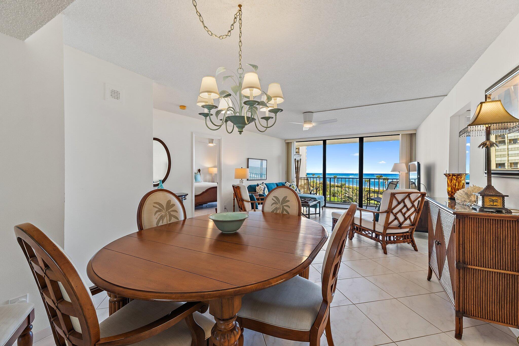 100 Ocean Trail Way, Unit 405 Jupiter, FL 33477 - Photo 14 of 38 a dining room with furniture a chandelier and window