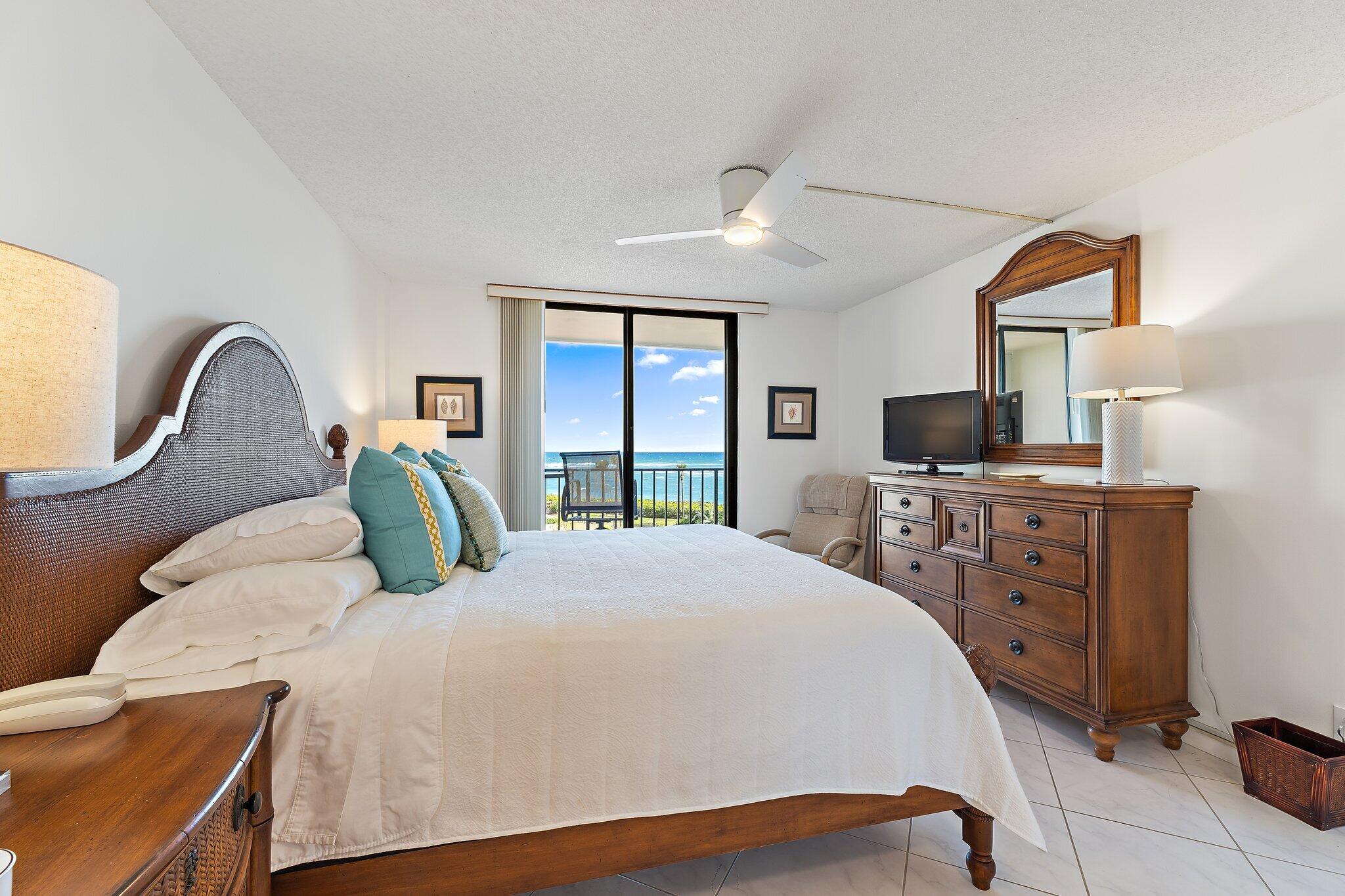 100 Ocean Trail Way, Unit 405 Jupiter, FL 33477 - Photo 22 of 38 a bedroom with a bed window and dresser