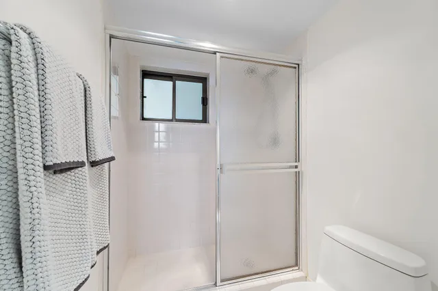 a bathroom with a shower and a toilet
