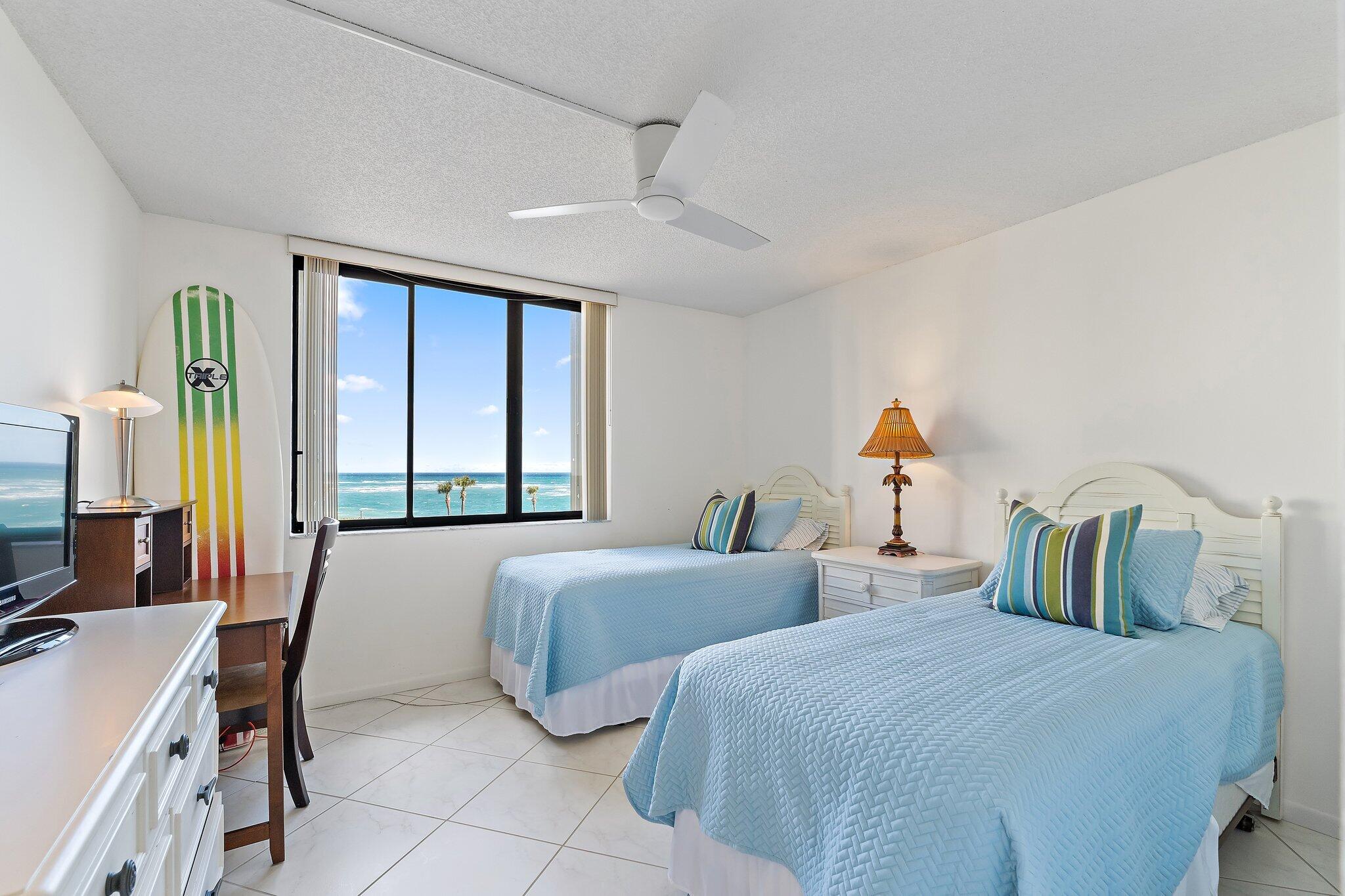 100 Ocean Trail Way, Unit 405 Jupiter, FL 33477 - Photo 30 of 38 a bedroom with two beds and a large window