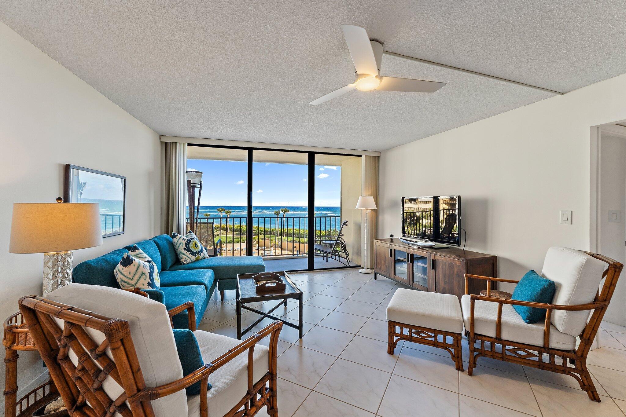 100 Ocean Trail Way, Unit 405 Jupiter, FL 33477 - Photo 3 of 38 a living room with furniture and a floor to ceiling window