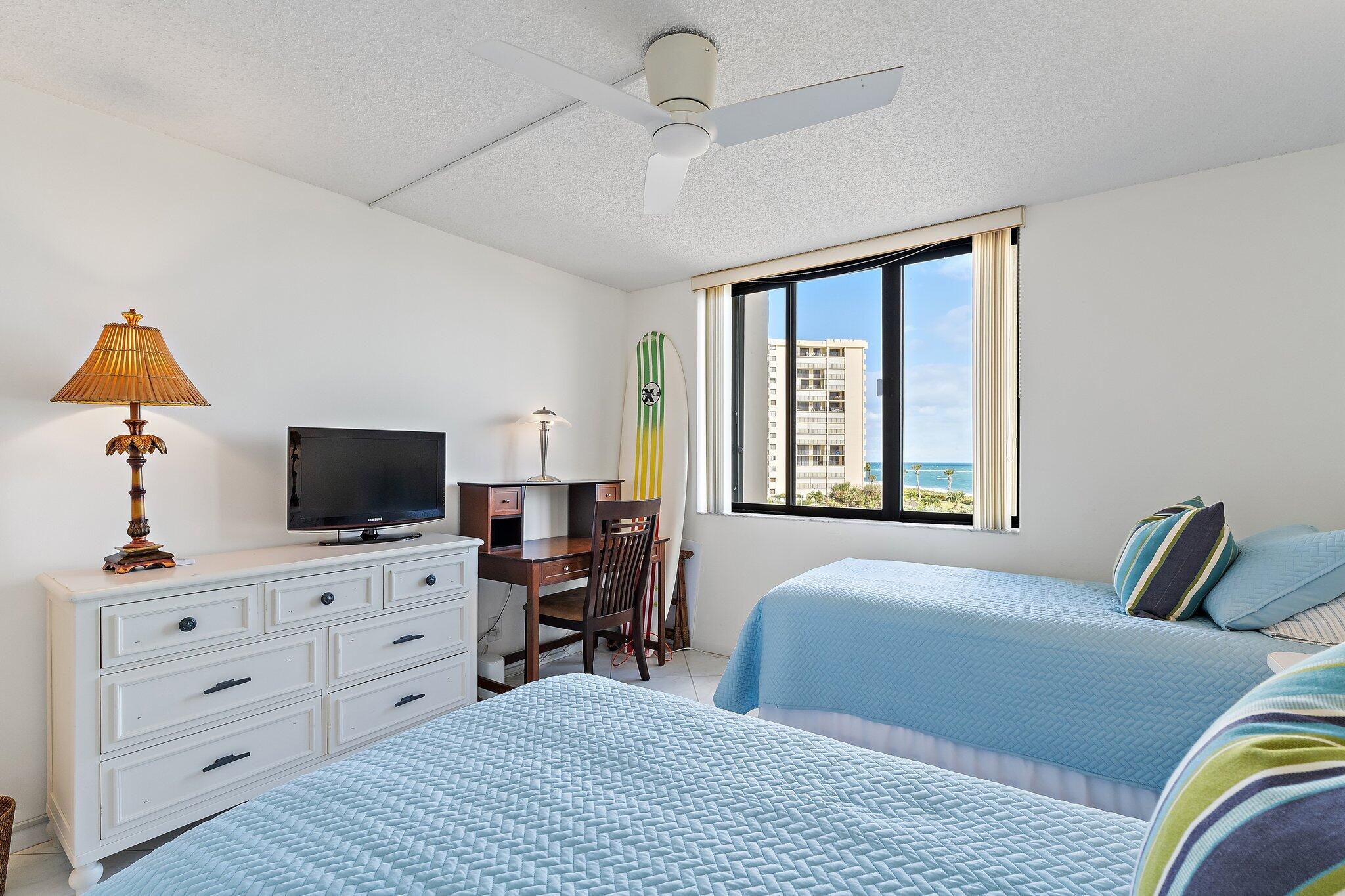 100 Ocean Trail Way, Unit 405 Jupiter, FL 33477 - Photo 31 of 38 a bedroom with a bed and a flat screen tv