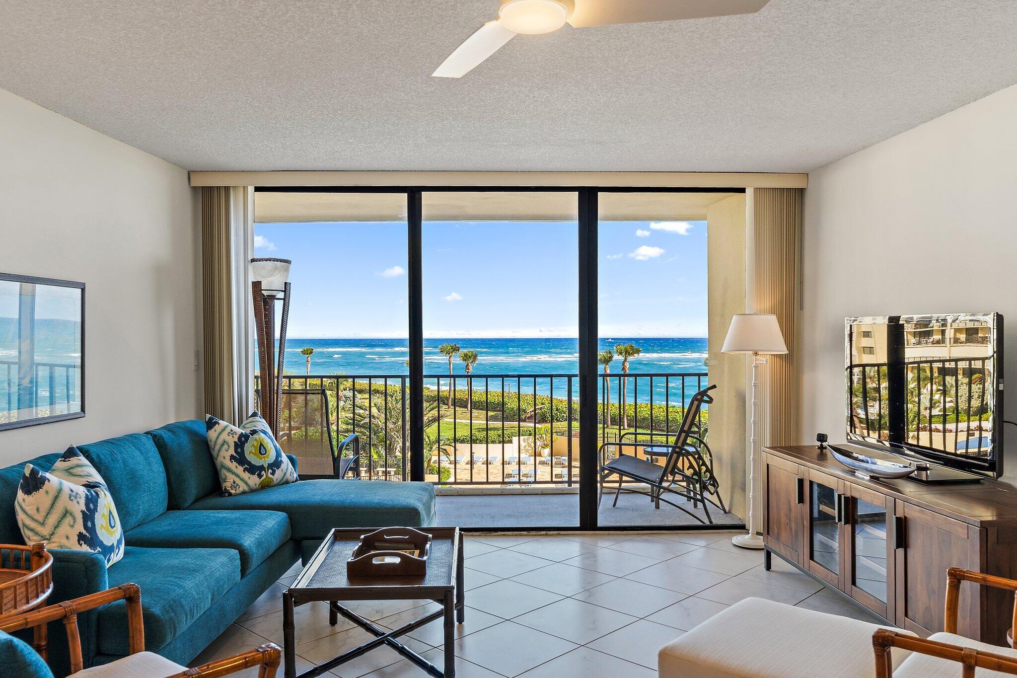 100 Ocean Trail Way, Unit 405 Jupiter, FL 33477 - Photo 6 of 38 a living room with furniture and a flat screen tv