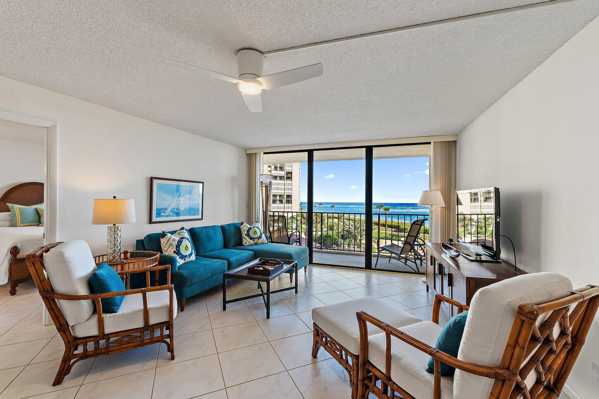 100 Ocean Trail Way, Unit 405 Jupiter, FL 33477 - Photo 7 of 38 a living room with furniture and a floor to ceiling window